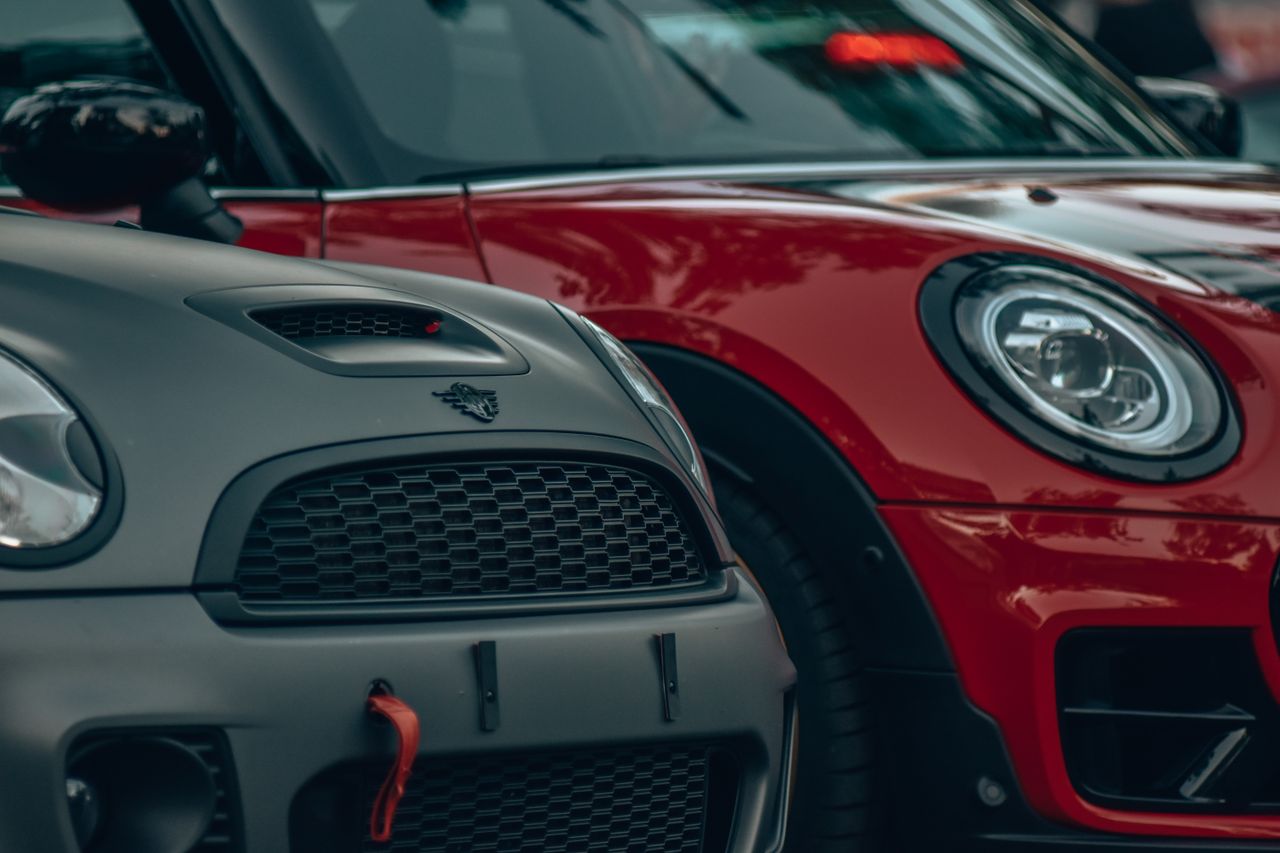 A detailed close-up view of Mini Cooper front grille and headlights.